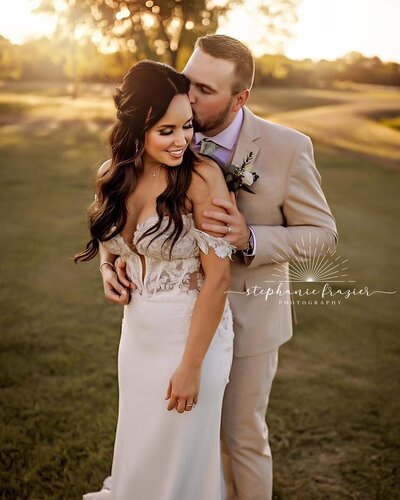 Bride holding peach and white wedding bouquet
