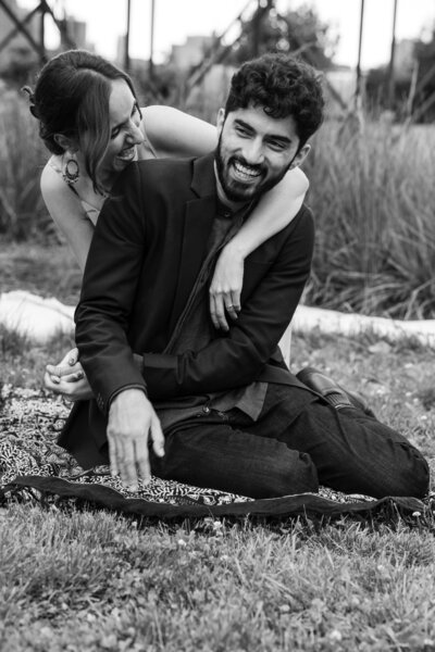 black and white couple of a young multi-racial couple, Latina gf with Indian by enjoying a moment in Astoria Socrates Park.