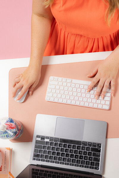 Hands typing on a computer