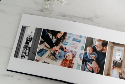 An open photo album displaying a mix of color and black-and-white photographs of a baby and their parents.