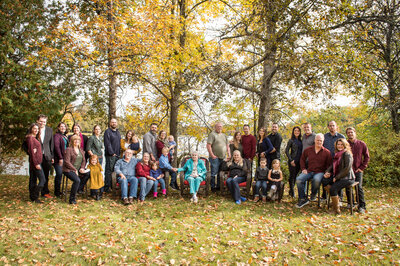 over thirty people sitting for a fall family photo