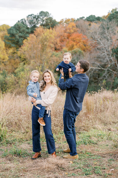 Family plays together during outdoor photo session in Raleigh NC with Worth Capturing