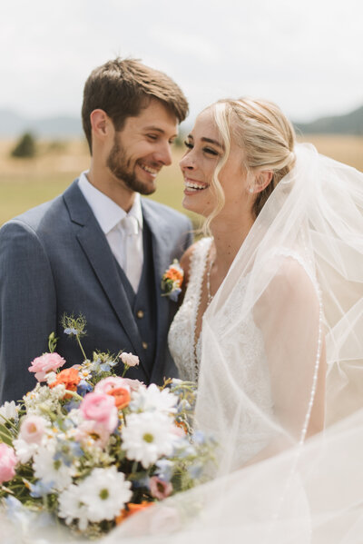 bride and groom walking down street at spruce mountain ranch