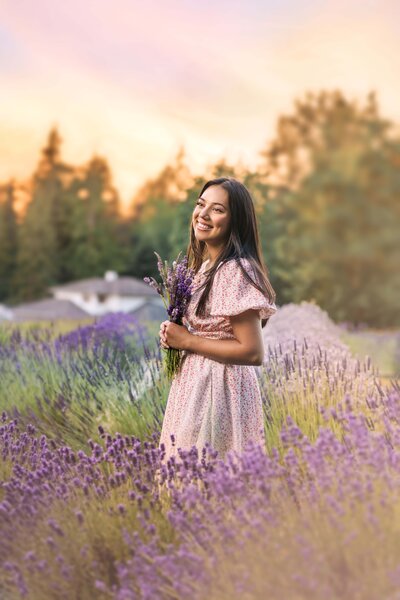 Tacoma Senior poses smiling in field of lavender at sunset