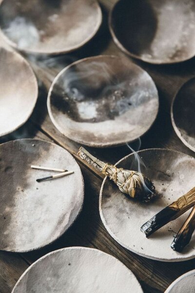 Burning sage with gentle smoke rising. Used for energetic clearing, grounding, and creating sacred space.
