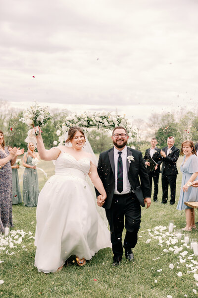 Couple laughing naturally during their wedding vows outdoors