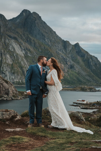 Elopment couple kissing on a mountain in Lofoten