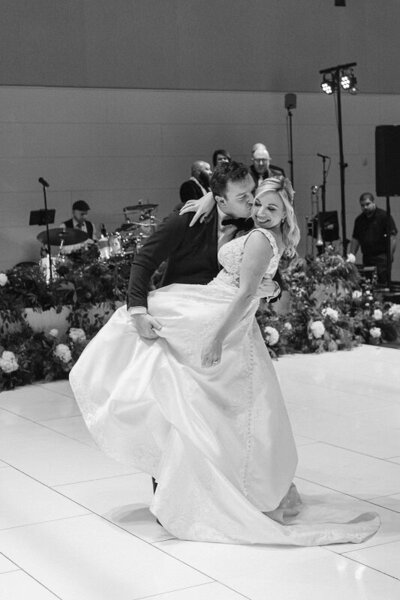 Bride and groom kissing during their first dance dip