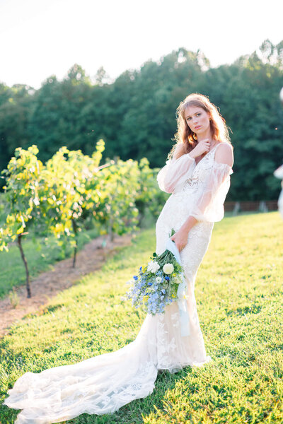 Brid taking portraits in a vineyard. Captured by Washington DC Wedding Photographer Bethany Aubre Photography.