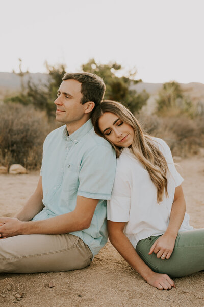 couple sitting down for photos in Joshua Tree California, photo by Kaitlyn Neeley, photographer in omaha