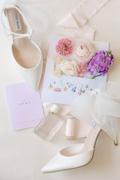 flat lay of wedding accessories and flowers