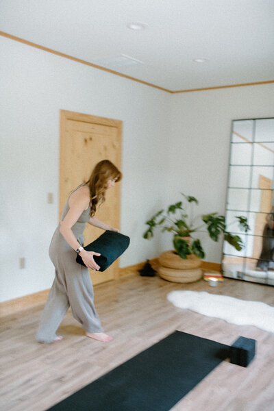 Practitioner setting up a studio space for a class at Alyn Wellness Studio