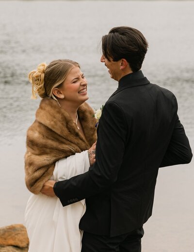 Bride and groom laughing during their first dance after their elopement at Lily Lake in Estes Park