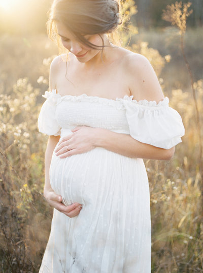 Expectant Mom holds her belly during photo session by Nashville Photographer Grace Paul