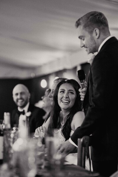 Bride laughing in Groom speech at Pylewell Park-1