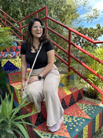 Maya laughs as she sits on the colorful mosaic steps of Afro House, an art gallery and gift shop featuring  the work of Afro descendants in Puerto Rico. 