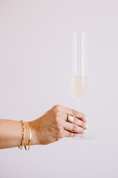 holding champagne flute