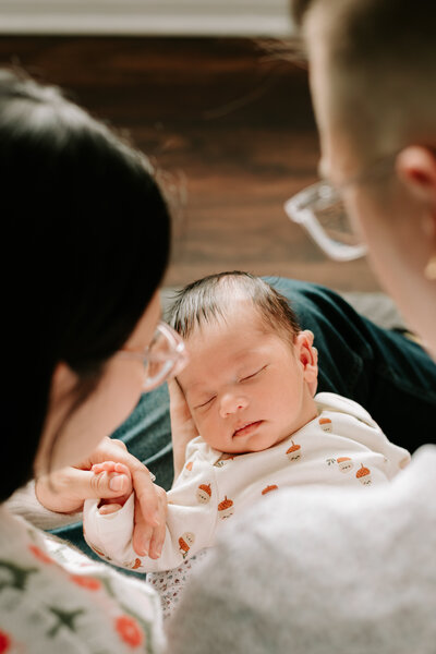 Mom playing with her newborn baby at home in Winnipeg