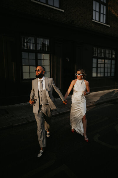 Bride and groom walk around Brixton for wedding photos in London. 