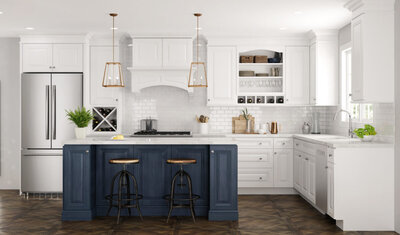 Bright kitchen remodel with white cabinetry and backsplash with a dark blue island all with gold hardware for accents. 