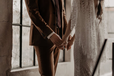 bride and groom holding hands