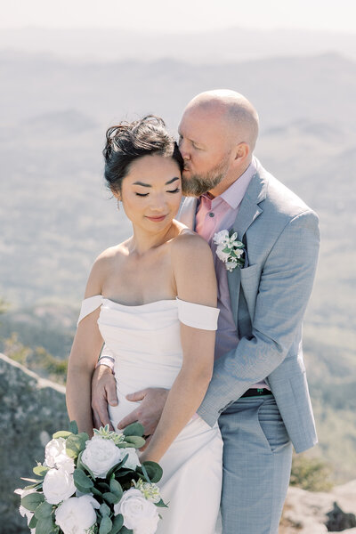 In an A-frame cabin in the Adirondack mountains, a couple enjoys a picnic on their elopement day.