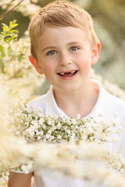 little boy missing top two teeth smiling during boise child photography