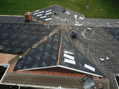 Roof underlayment installation in progress.