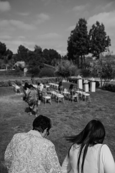 Wedding guest walking down to take their seats for a wedding in Temecula, in black and white