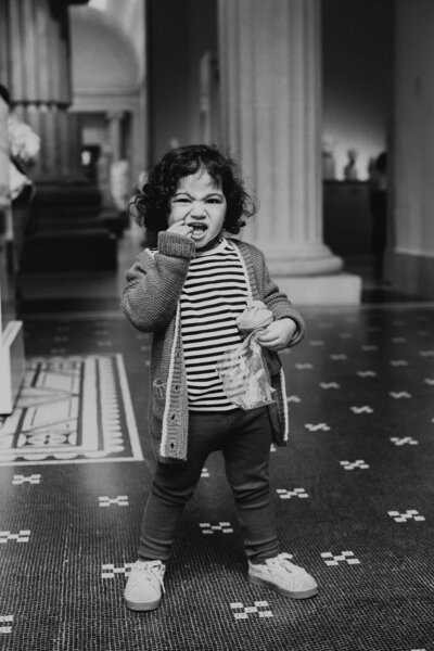 toddler eating snacks at the met museum during nyc family photo session