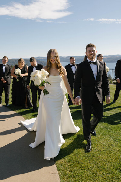 Beautiful bride and groom kiss as they walk back down the aisle after getting married in Big Sky Montana