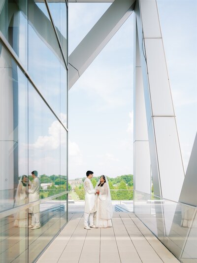 Indian Nikkah wedding ceremony at Clinton Center Library in Little Rock with bride and groom standing on terrace