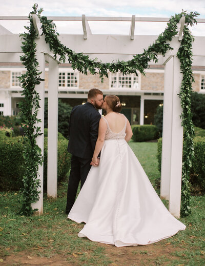 Groom kissing bride’s temple during sunset – Atlantic Beach luxury wedding photography.