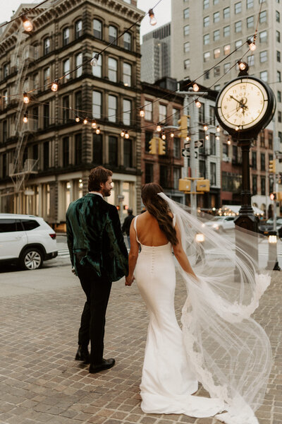 bride and groom walking on cobblestone