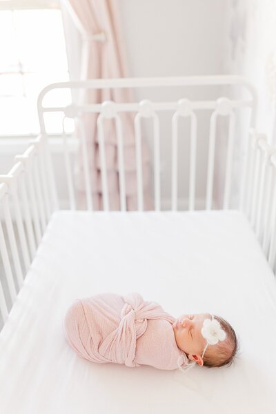 swaddled baby in a crib by Knoxville Wedding Photographer, Amanda May Photos