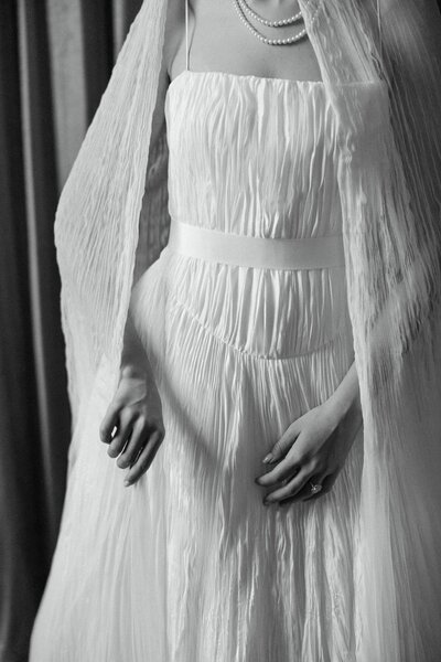Black and white bridal portrait captured at Davis and Grey Farms in Texas. A timeless fine art wedding image featuring a bride holding a romantic bouquet with soft shadows and a flowing veil.