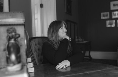 Woman smiling while sitting at a table