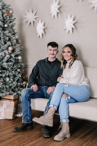 Styled Christmas photo setup at Evermore Place in Gray, Maine featuring a flocked tree and cozy seating.