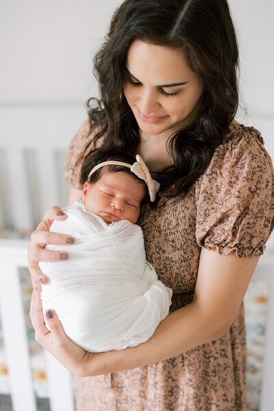 Mother snuggles her baby to her face during her studio newborn sesison with Delco Newborn Photographer Samantha Jay