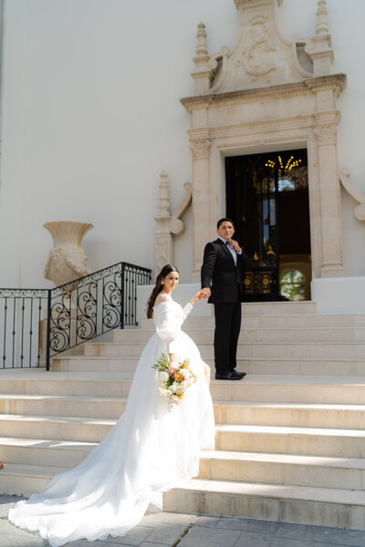 elegant bride and groom in front of their chateau wedding venue