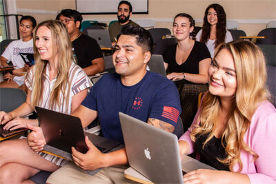 Students with laptops seated and listening to lecture Whittier College