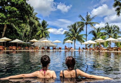 All-inclusive Caribbean resort with palm-shaded infinity pool and oceanfront relaxation.