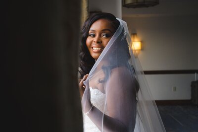 Haitian bride touching her wedding veil