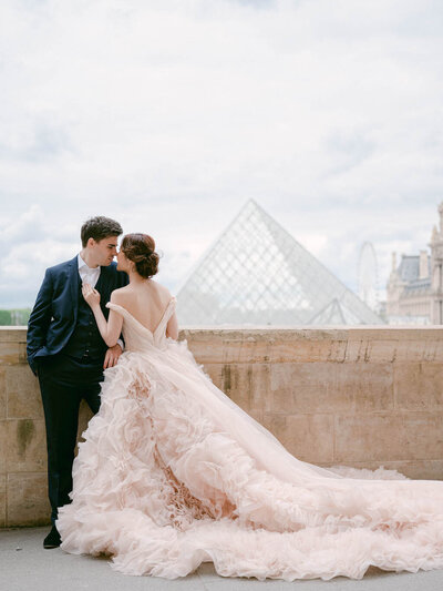 Bride in a bespoke Galia Lahav wedding dress and groom in a black tuxedo at The Arts Club, London, inspired by 90's supermodel style.