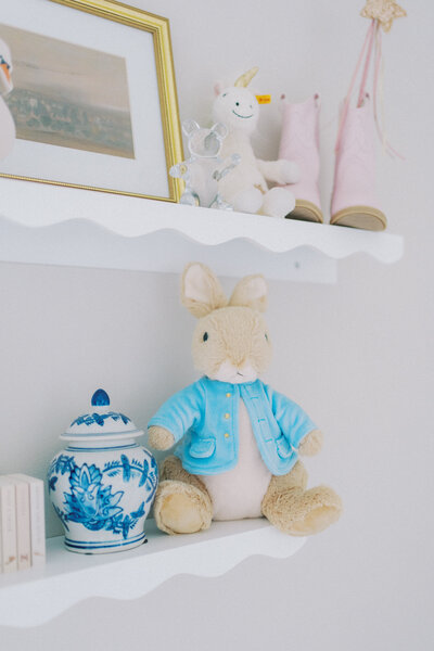 a photo of a baby toy and knick knack on a shelf in a nursery