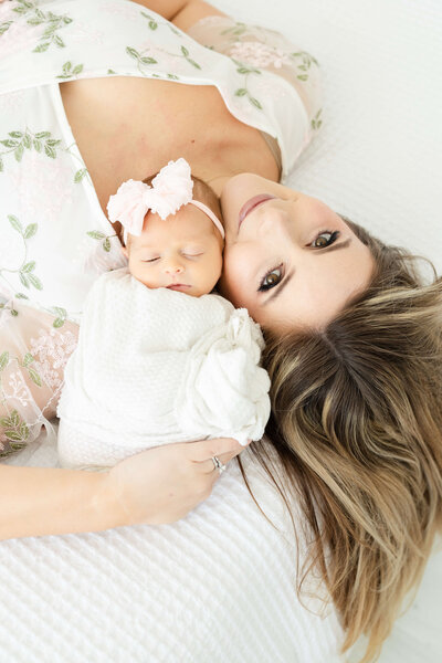 Mom and baby posing  and smiling at the camera
