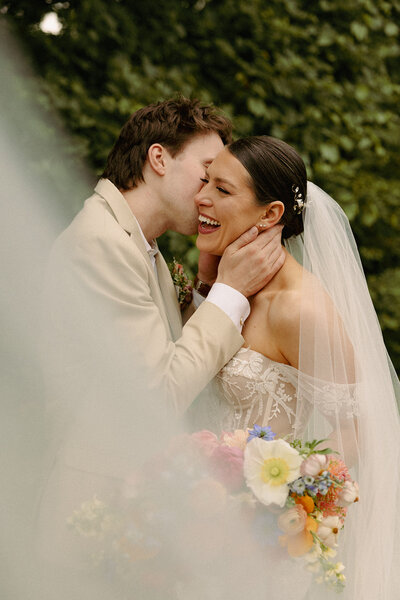 Bride and groom walking down aisle and getting confetti tossed at them