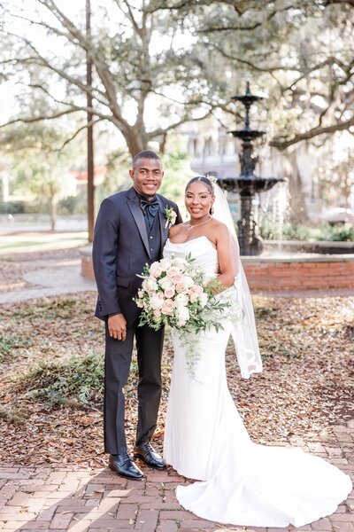 A joyful portrait of Mariah + Steevantz after their elopement ceremony at Lafayette Square in Savannah, captured as part of our Savannah Elopement Package.