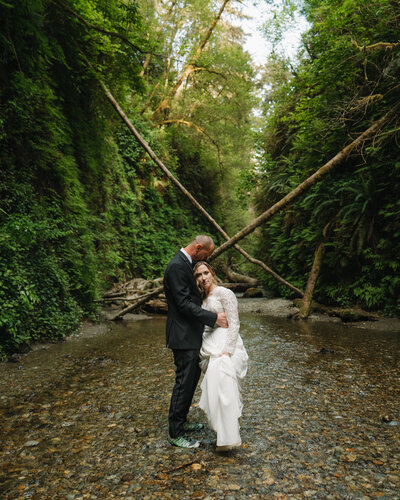 couple dancing under trees