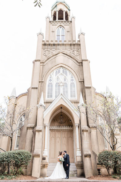 Couple in front of a synagogue in Savannah on their wedding day